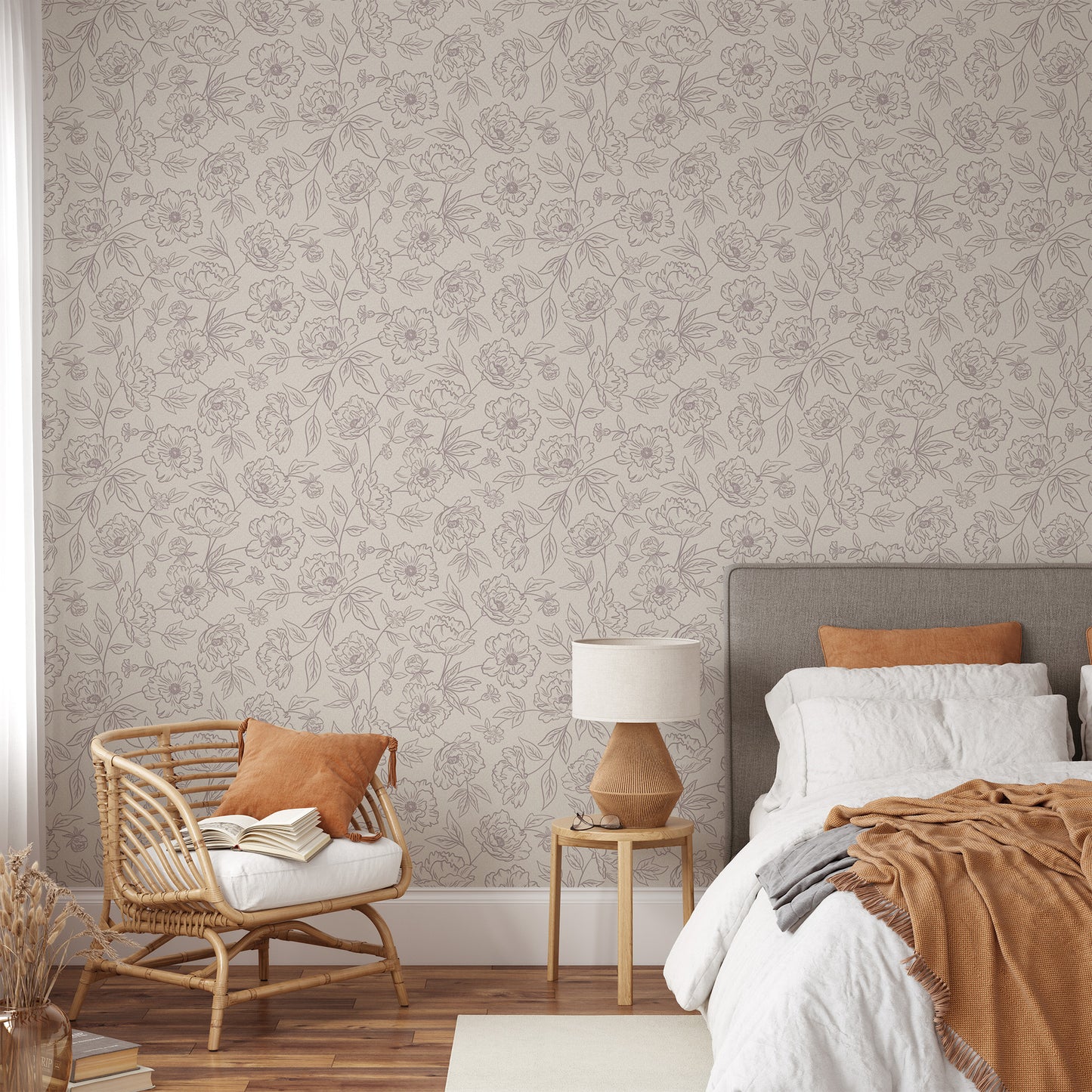 Anemone Blooms Wallpaper in Rose shown in a bedroom.