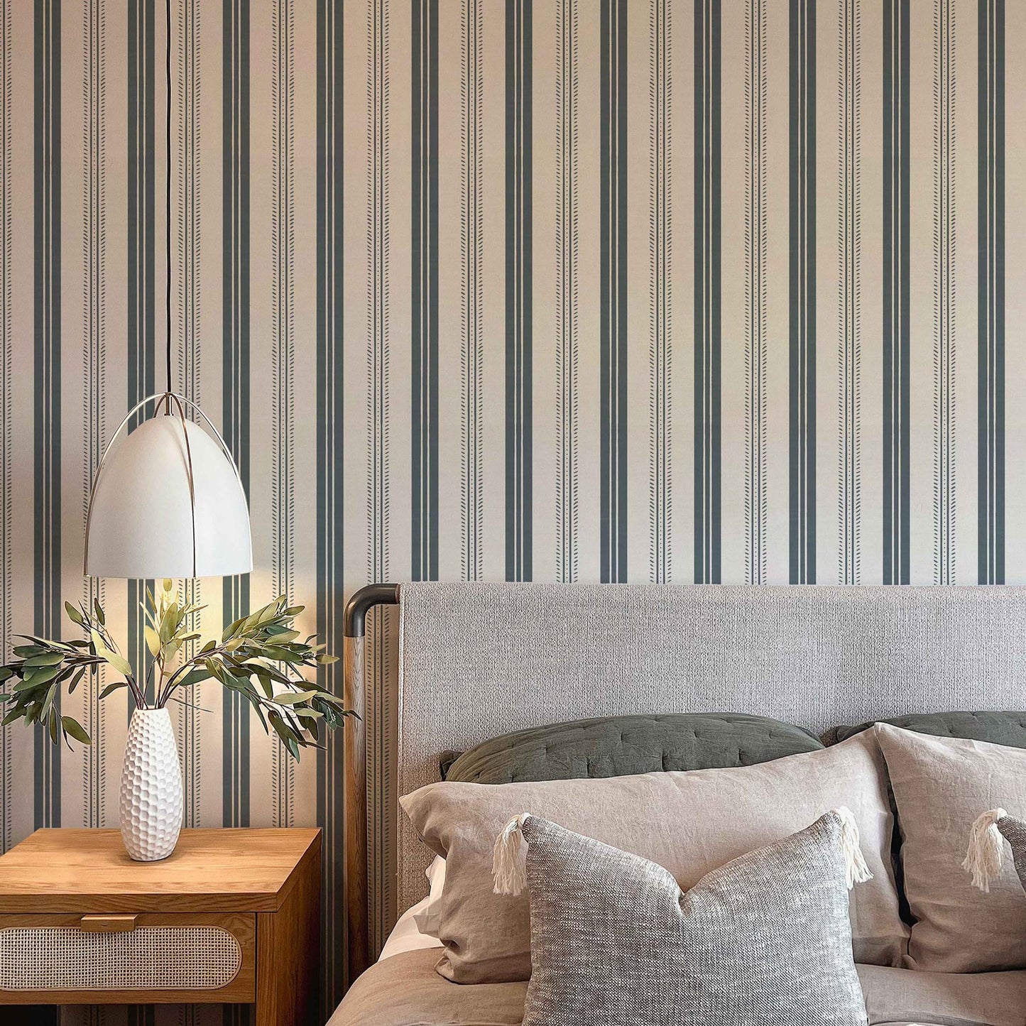 Antique Linen Stripe Wallpaper in Rain Cloud on Cream shown in a bedroom.