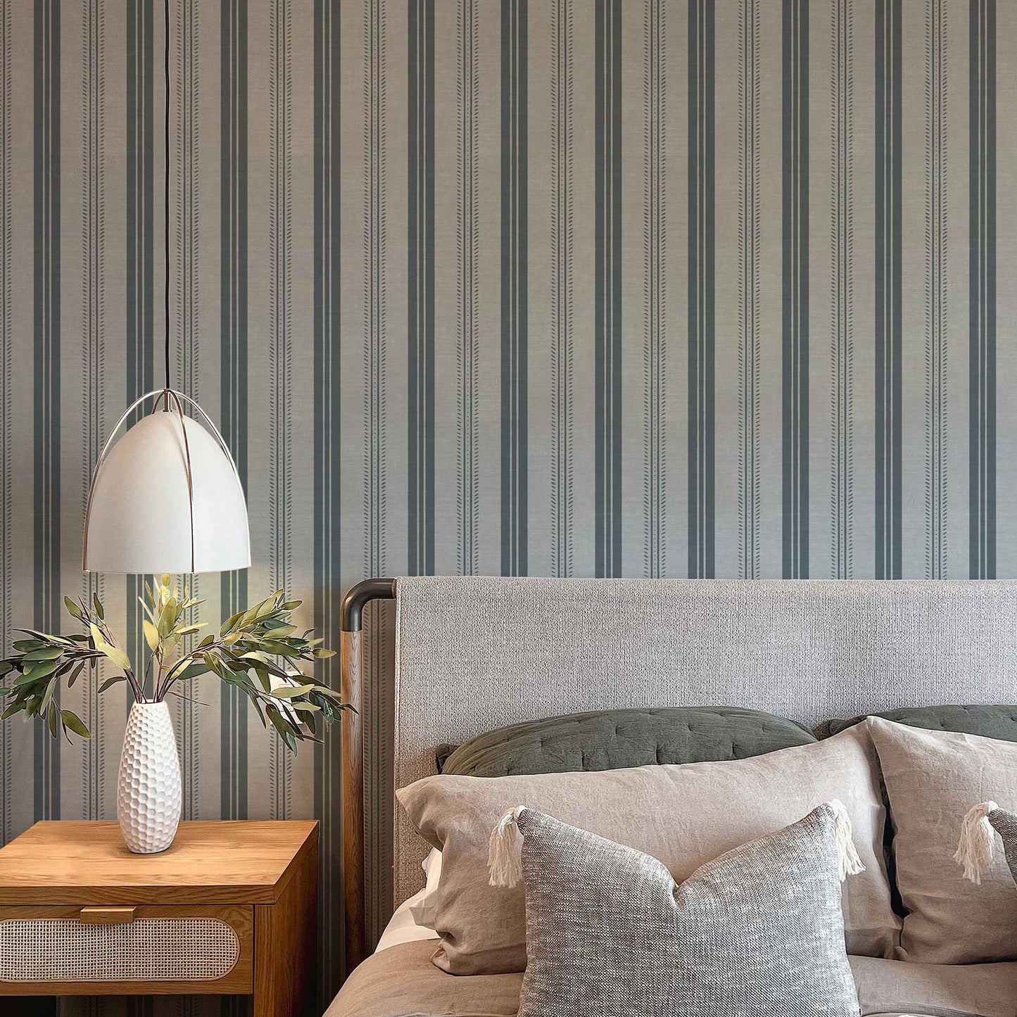 Antique Linen Stripe Wallpaper in Rain Cloud shown in a bedroom.