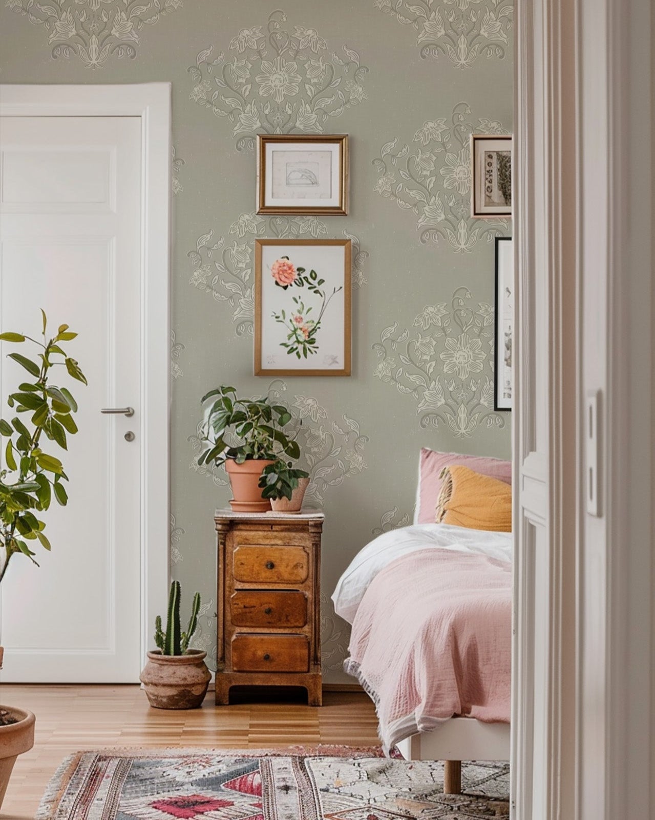 Blooming Block Print Wallpaper in Dry Sage shown in a bedroom.