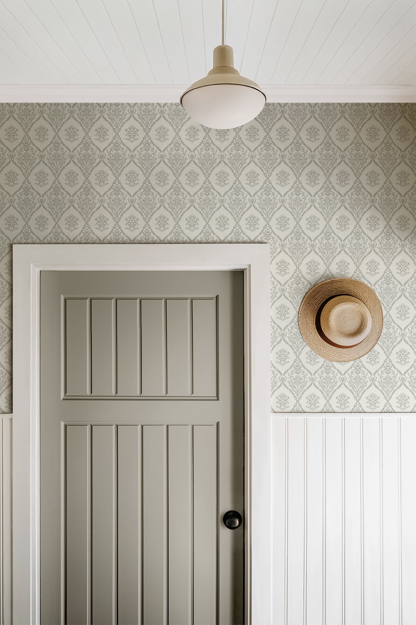 Fine Line Floral Wallpaper in Green shown in a hallway.