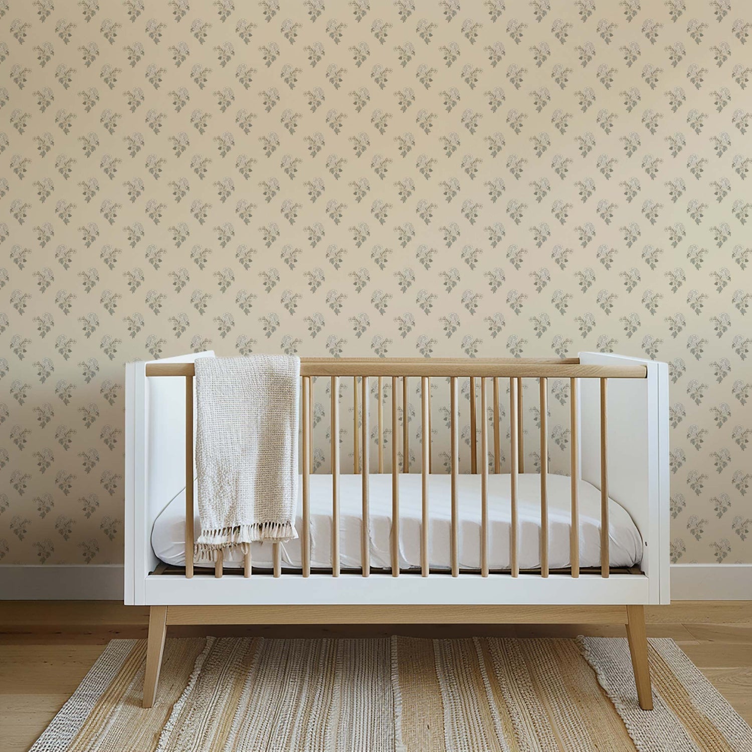 Foraged Peonies Wallpaper in Sand shown in a nursery
