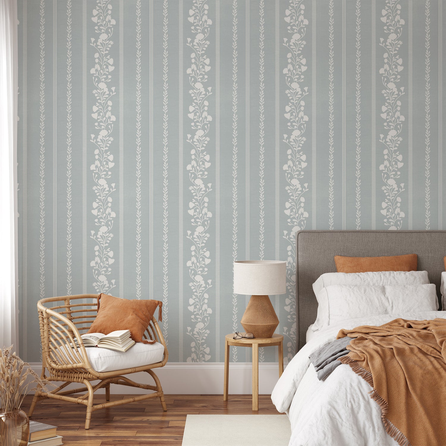 Sweet Floral Stripe Wallpaper in Cloudy Blue shown in a bedroom
