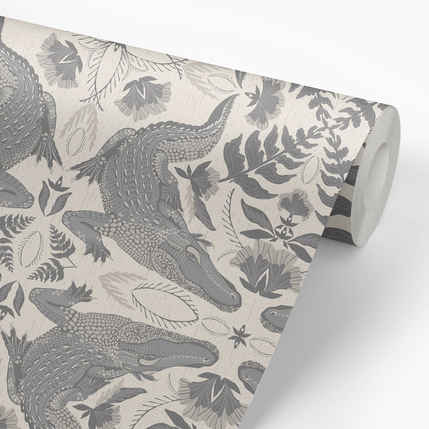 Roll of wallpaper with crocodile and leaf pattern on a neutral background