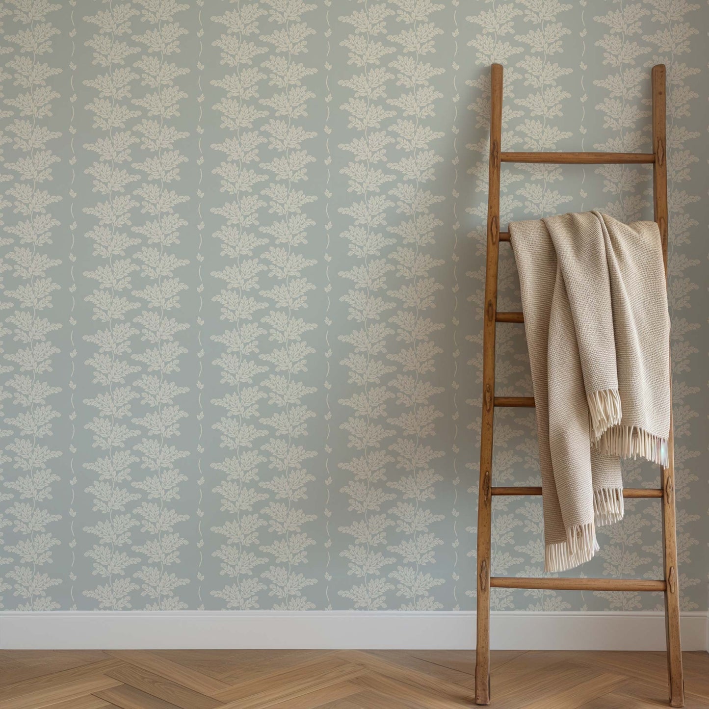 Elegant Branches Wallpaper in Pale Blue shown on a wall