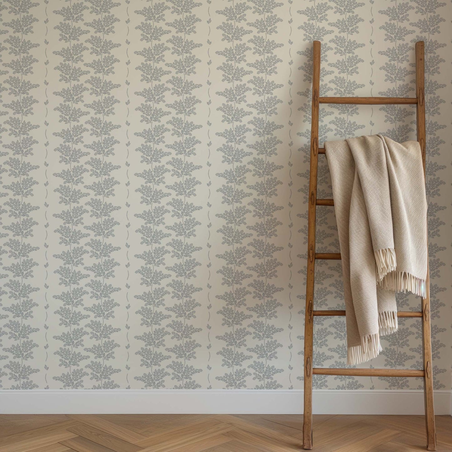 Elegant Branches Wallpaper in Dusty Blue Branches shown on a wall
