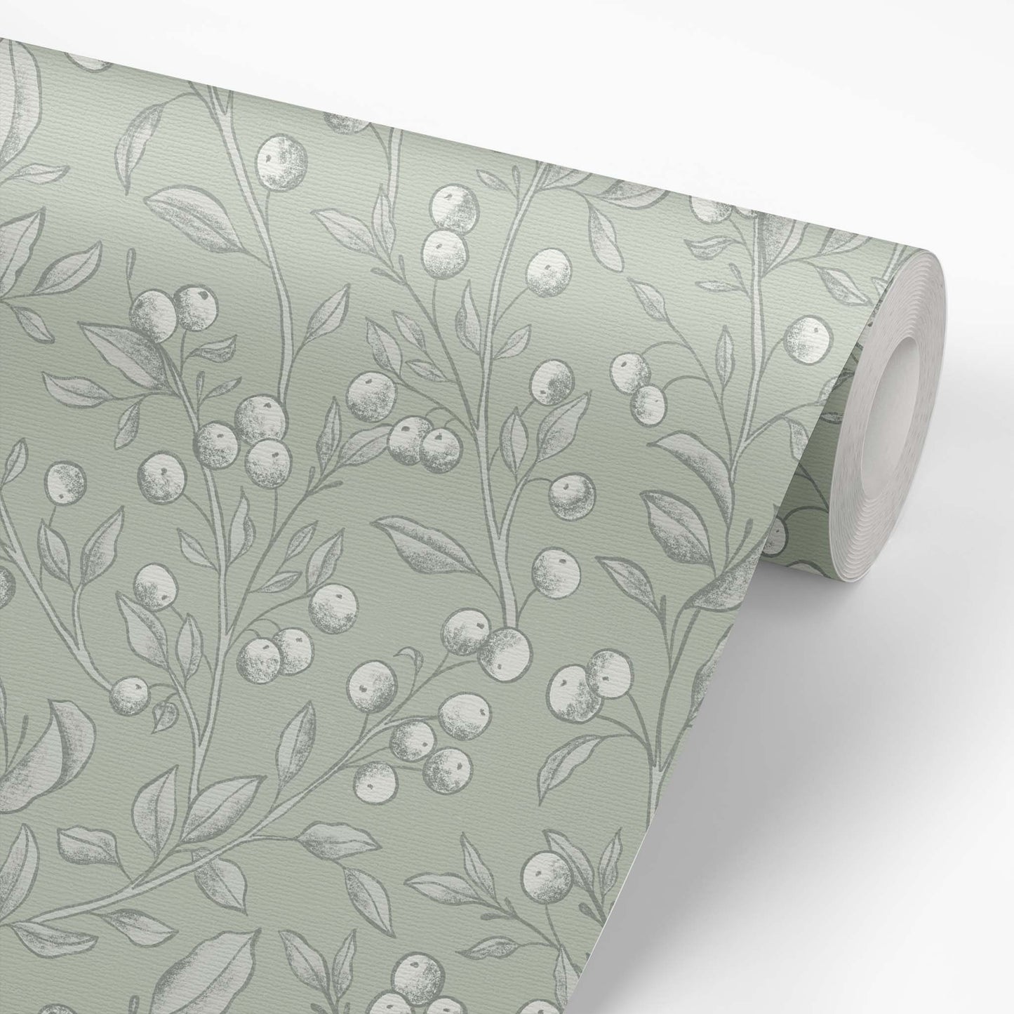 This wallpaper roll preview of our Berries Wallpaper in Light Sage shows our peel and stick, removable wallpaper with hand-drawn sketched berries in light sage and white by artist Mariah Cottrell.