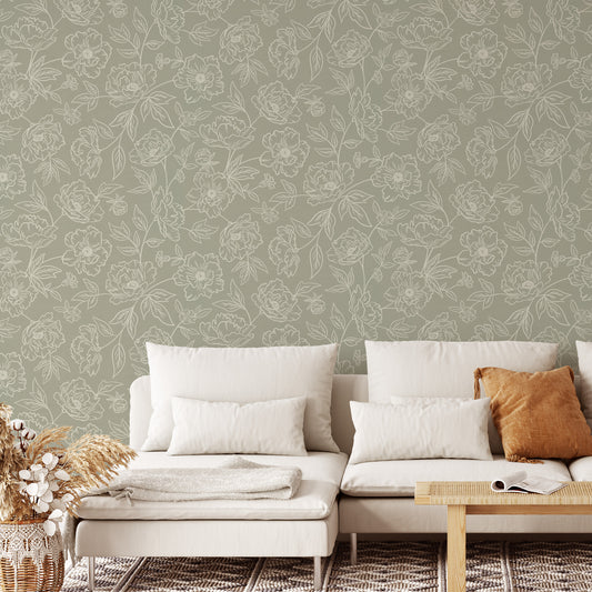 Anemone Blooms Wallpaper in Dry Sage shown in a living room.