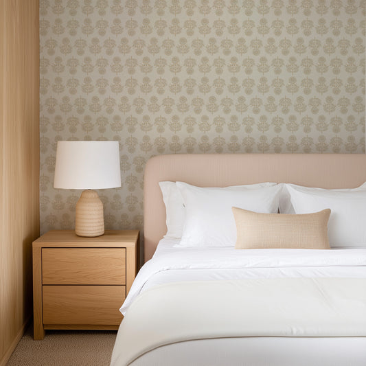Neatly made bed with white bedding and beige pillows in a bedroom setting. Wallpaper is Large Antique Floral Rows in neutral colors.