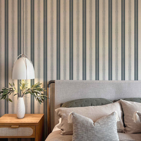 Antique Linen Stripe Wallpaper in Rain Cloud on Cream shown in a bedroom.