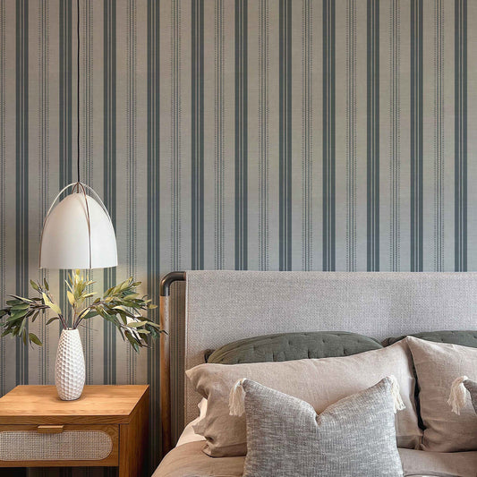 Antique Linen Stripe Wallpaper in Rain Cloud shown in a bedroom.