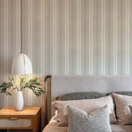 Antique Linen Stripe Wallpaper in Sea Salt shown in a bedroom