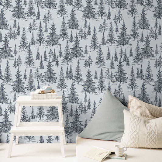 Winter Pines Wallpaper in Hale Navy shown in a bedroom