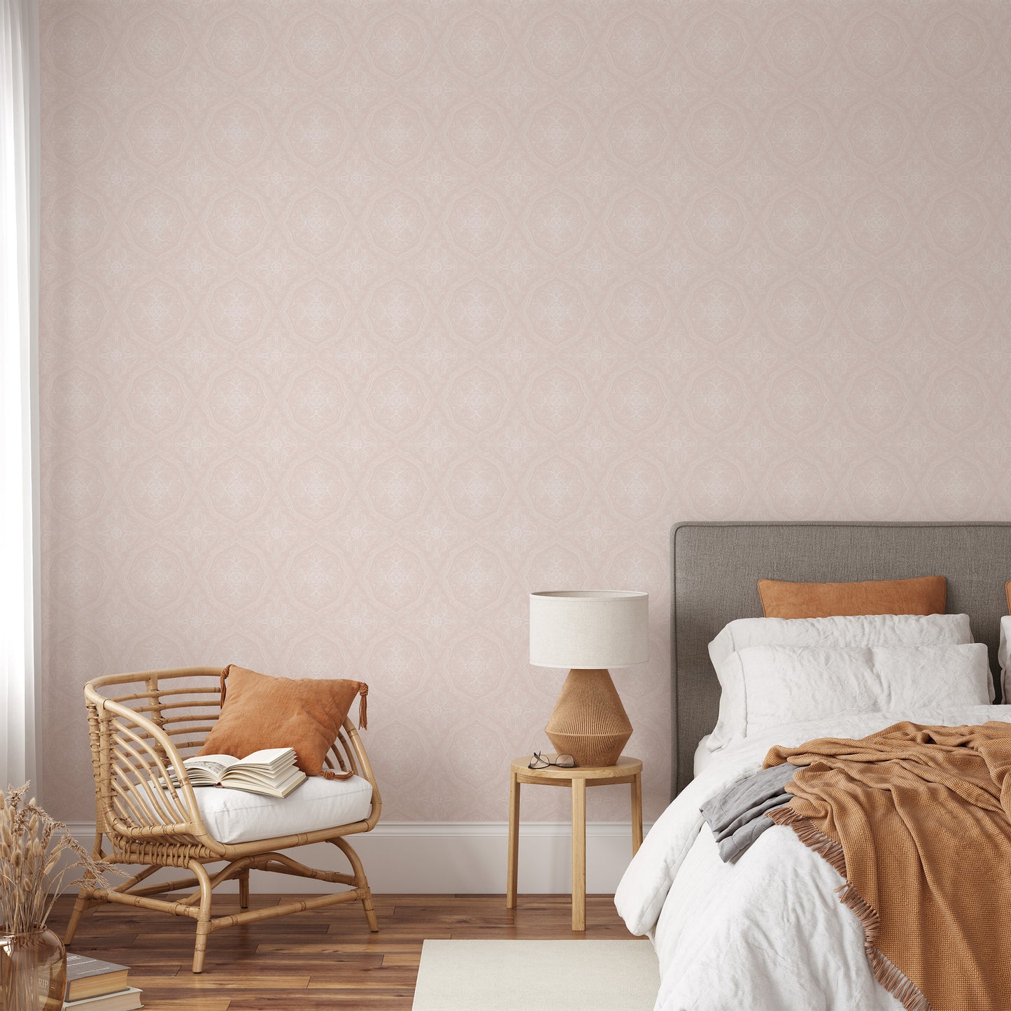 Cozy bedroom with a bed, chair, and lamp against a wall with pink wallpaper