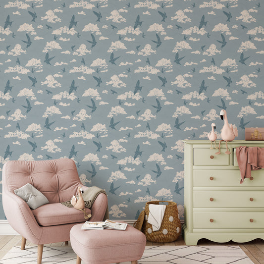 Dancing Swallows Wallpaper in Dusty Blue shown in a nursery.