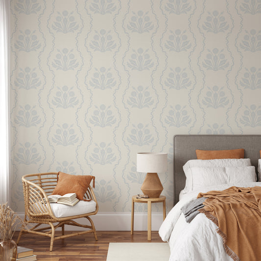 Dandelion Block Printed Wallpaper in Barely Blue shown in a bedroom.