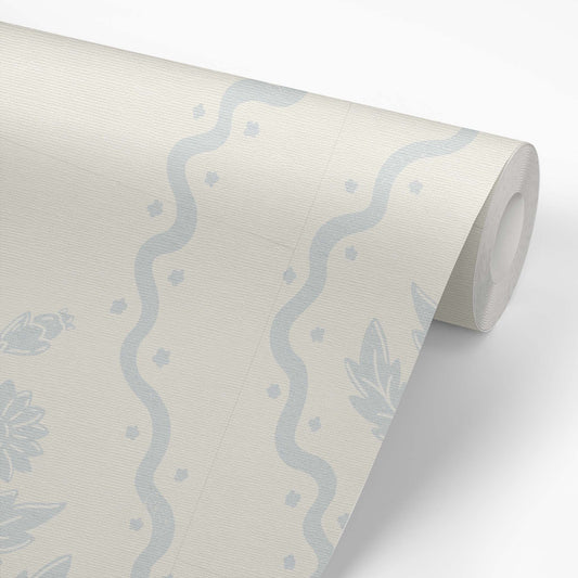 Dandelion Block Printed Wallpaper in Barely Blue shown on a wallpaper roll.