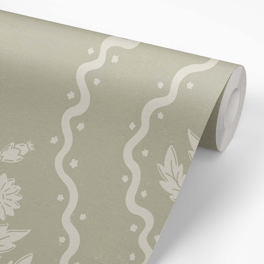 Dandelion Block Printed Wallpaper in Cream on Dry Sage shown on a wallpaper roll.