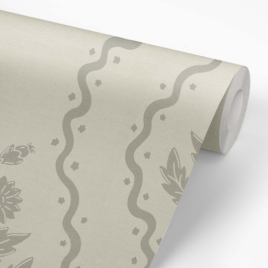 Dandelion Block Printed Wallpaper in Dry Sage shown on a wallpaper roll.