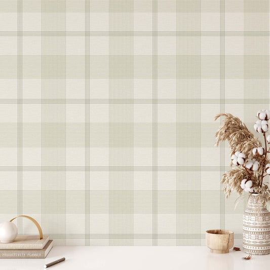 Plaid patterned wallpaper in sage with decorative items on a white surface