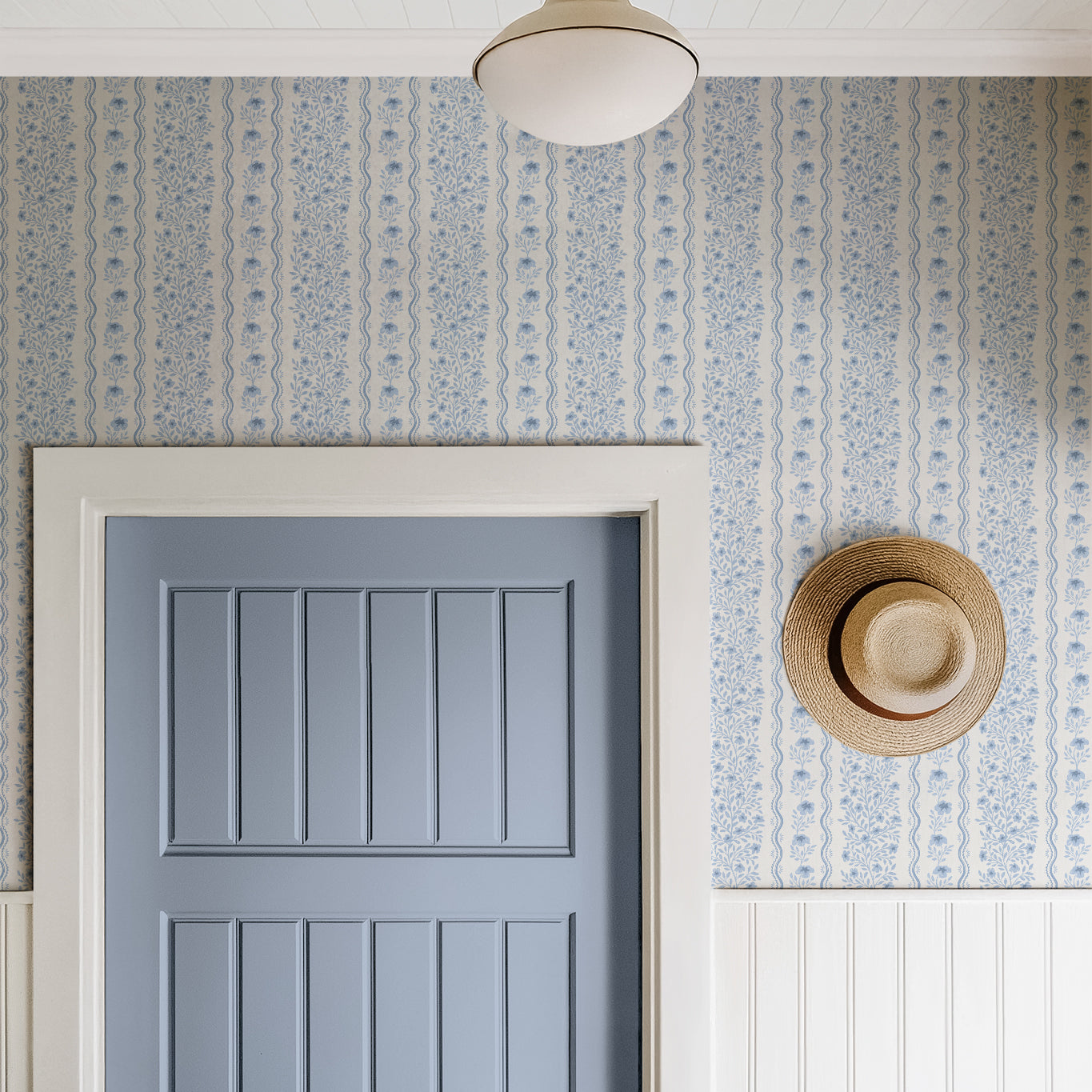 Etta Wallpaper in blue shown in a hallway.