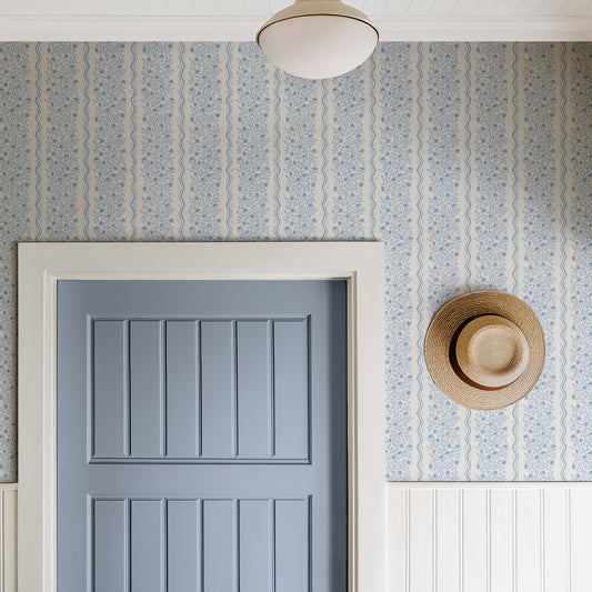 Faye Floral Wallpaper in Blue shown in a hallway.