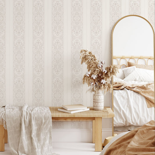Bedroom with patterned wallpaper, wooden bench, and bed.