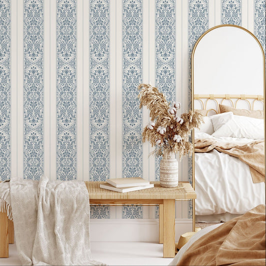 Decorative bedroom with striped wallpaper and wooden bench.