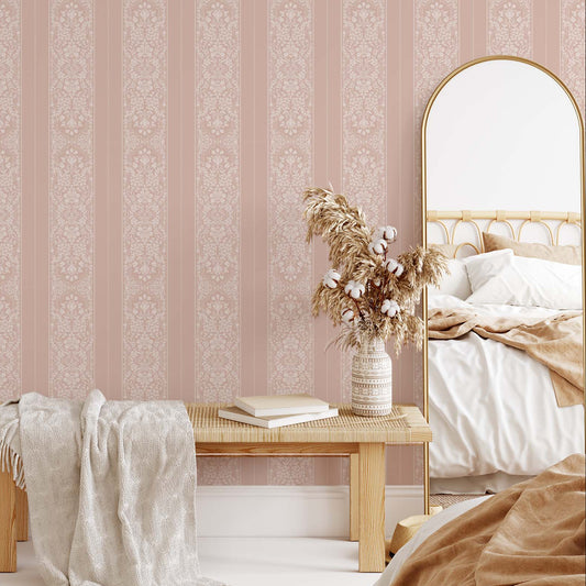 Bedroom with pink striped wallpaper, wooden bench, and mirror.