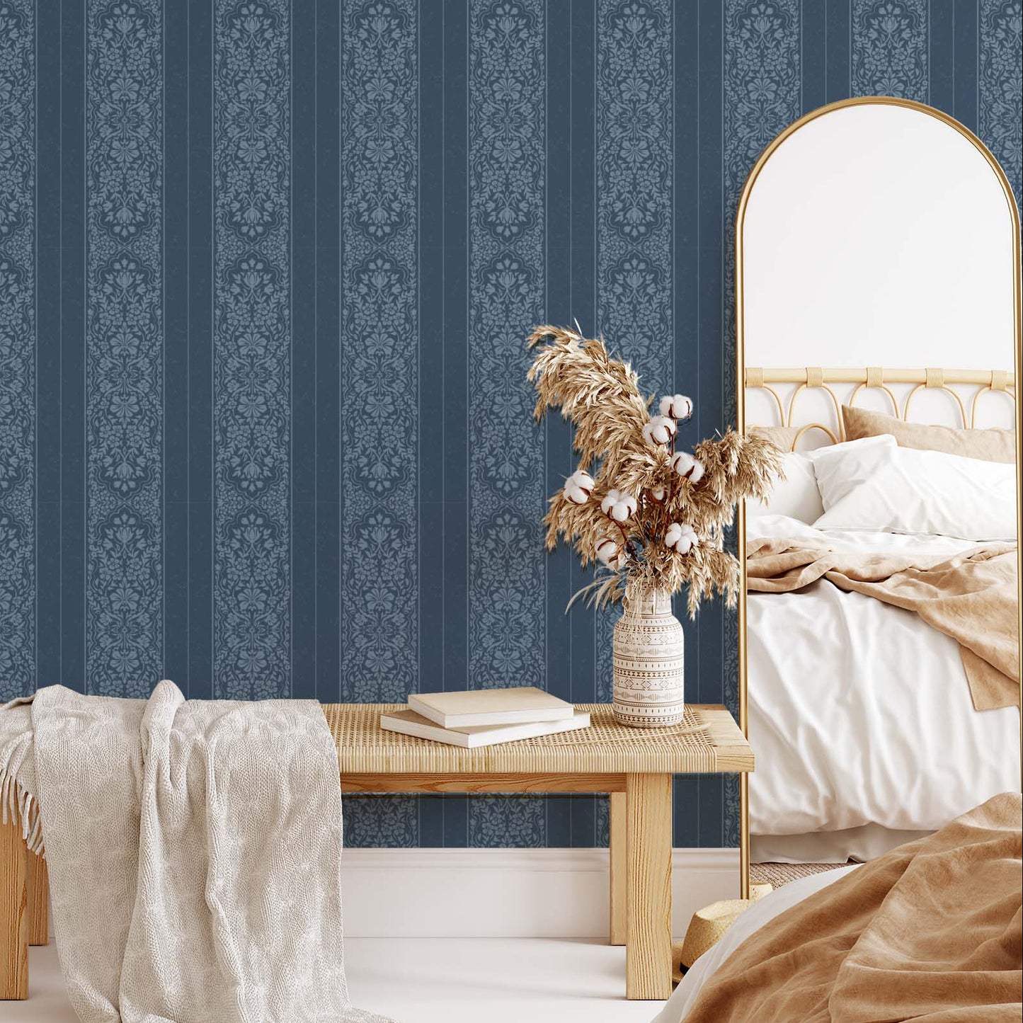 Bedroom with blue striped wallpaper, wooden bench, and decorative mirror.