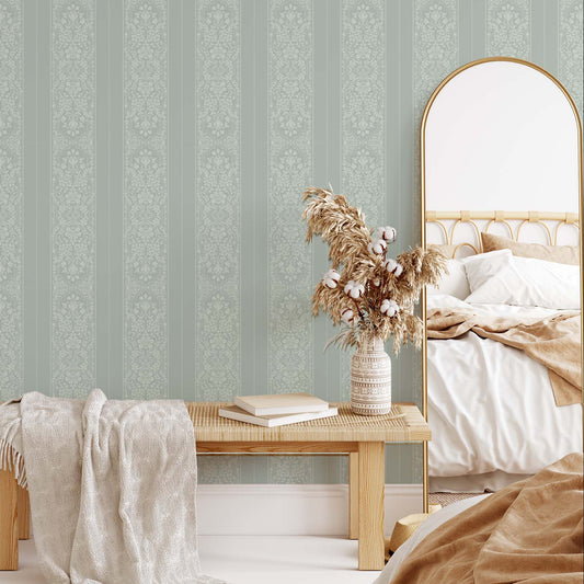 Bedroom with striped wallpaper, wooden bench, and mirror.