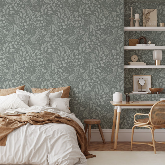 Bedroom with floral wallpaper, bed, desk, and chair.