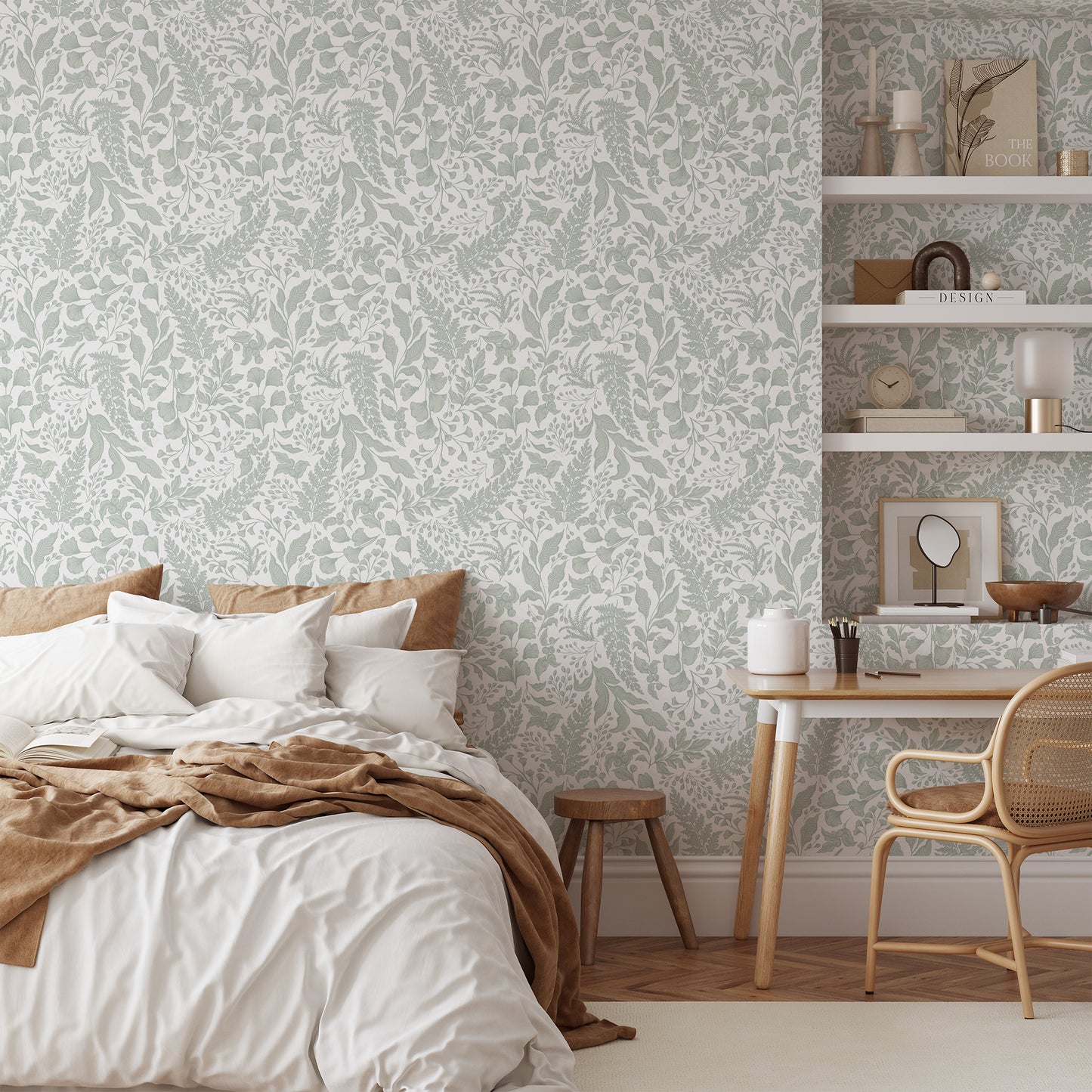 Neatly made bed with white bedding and brown blanket in a room with patterned wallpaper and a small desk.