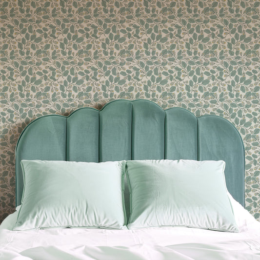 Evening Bloom Wallpaper in Sage shown in a bedroom.