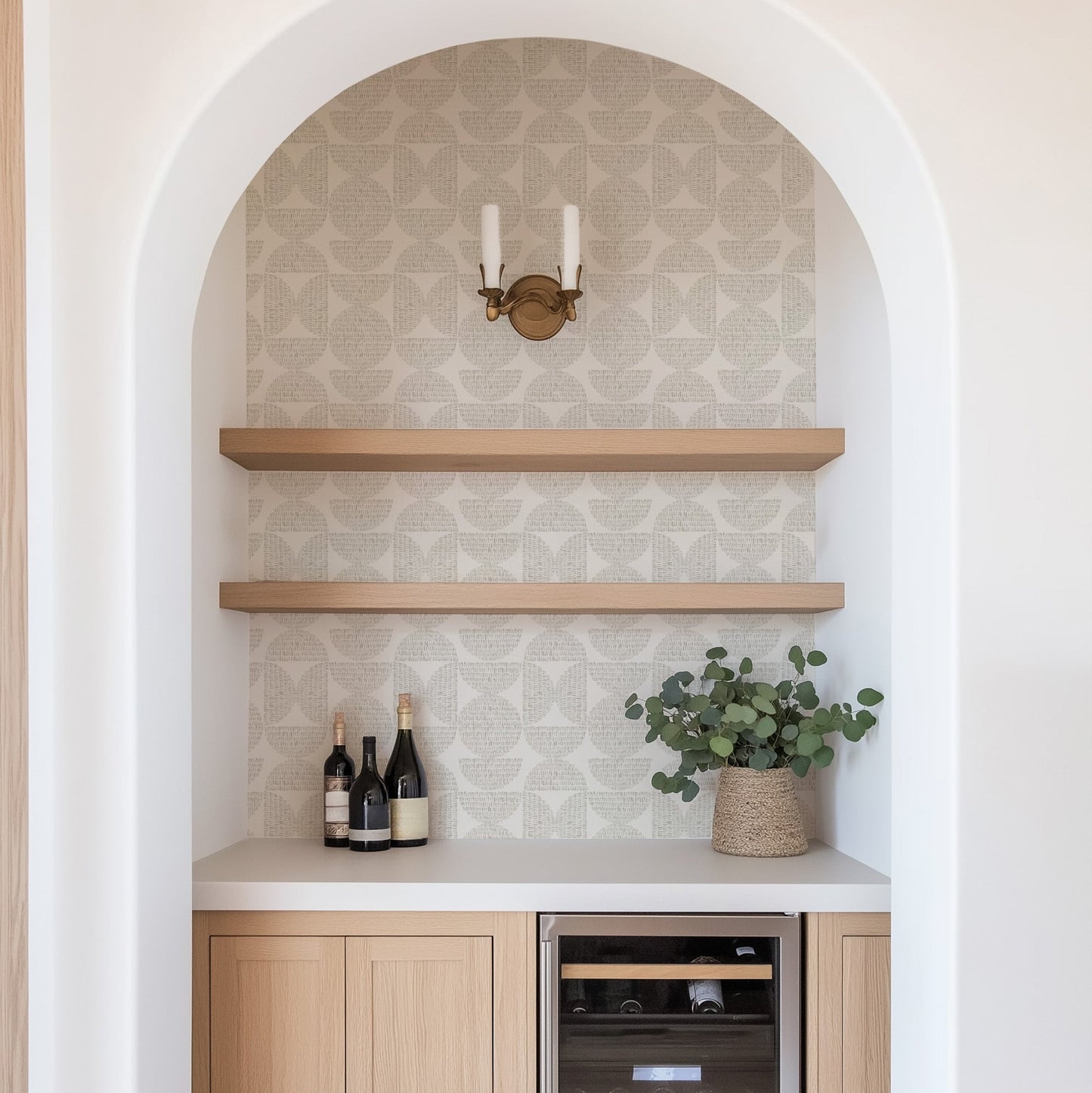 Modern kitchen with wooden shelves, wine bottles, and a plant. Featured wallpaper is Half Circle Blocks, a geometric wallpaper by Ayara.