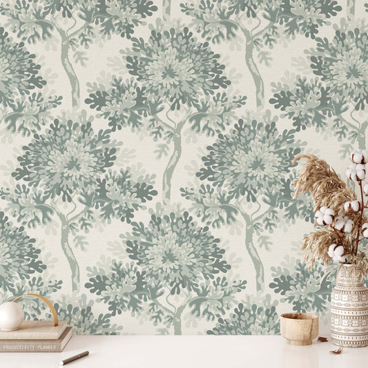 Wallpaper with green leaf pattern, table with decor items against the wall.