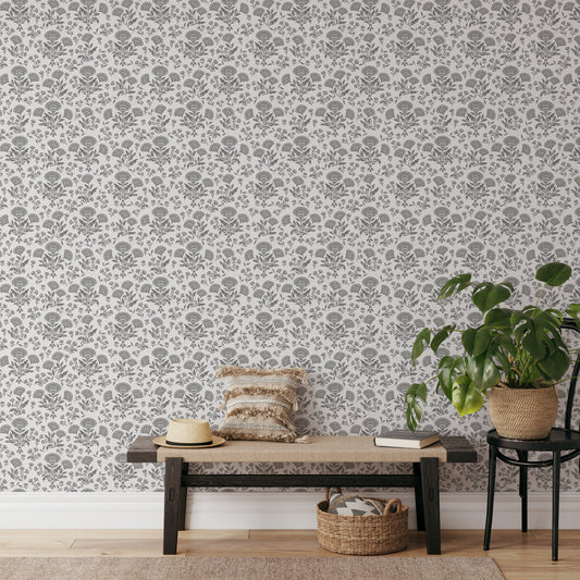 Living room with floral wallpaper, wooden bench, and potted plant.