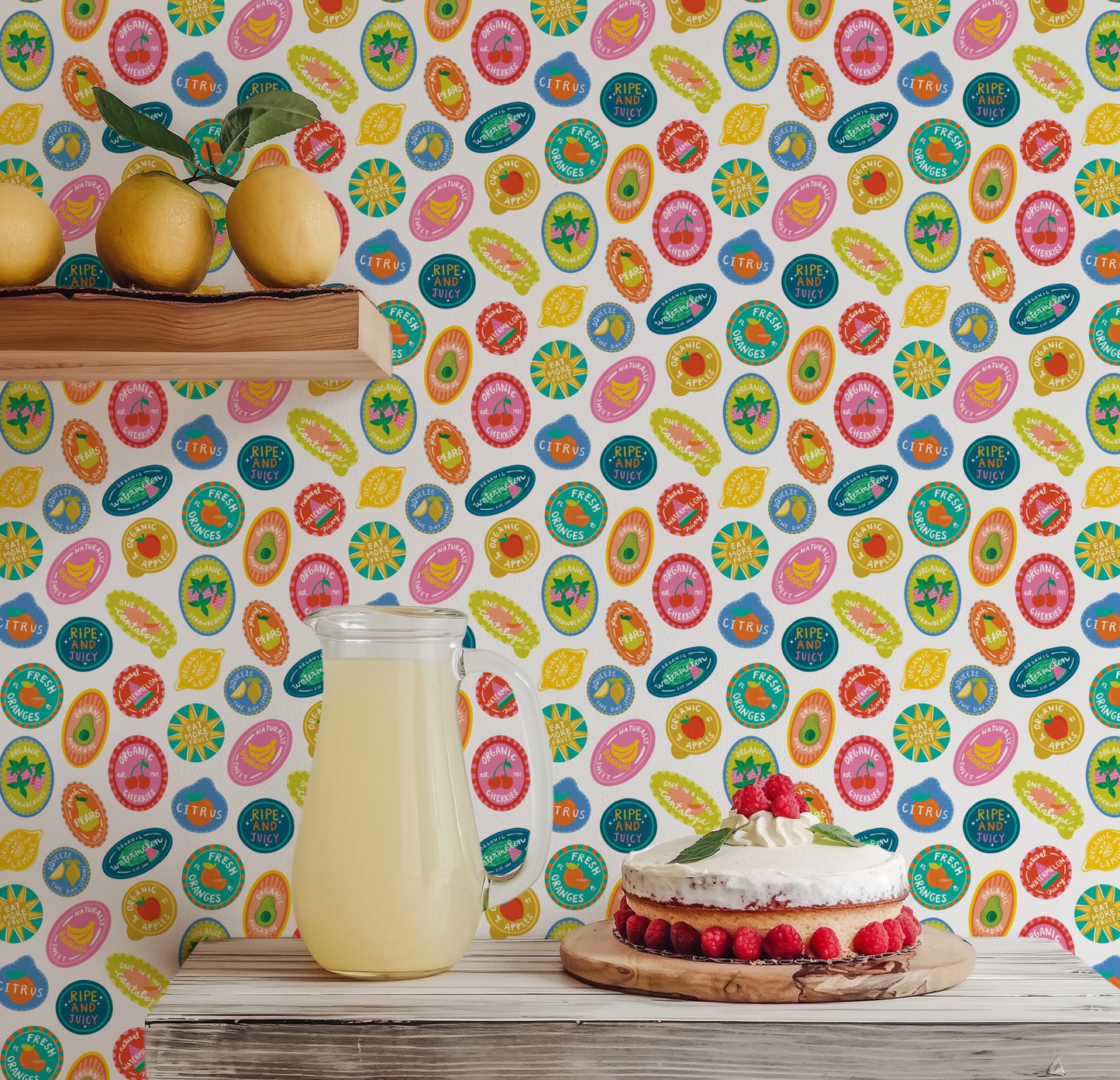 Jar of lemonade and cake on a wooden surface with a colorful patterned wallpaper background
