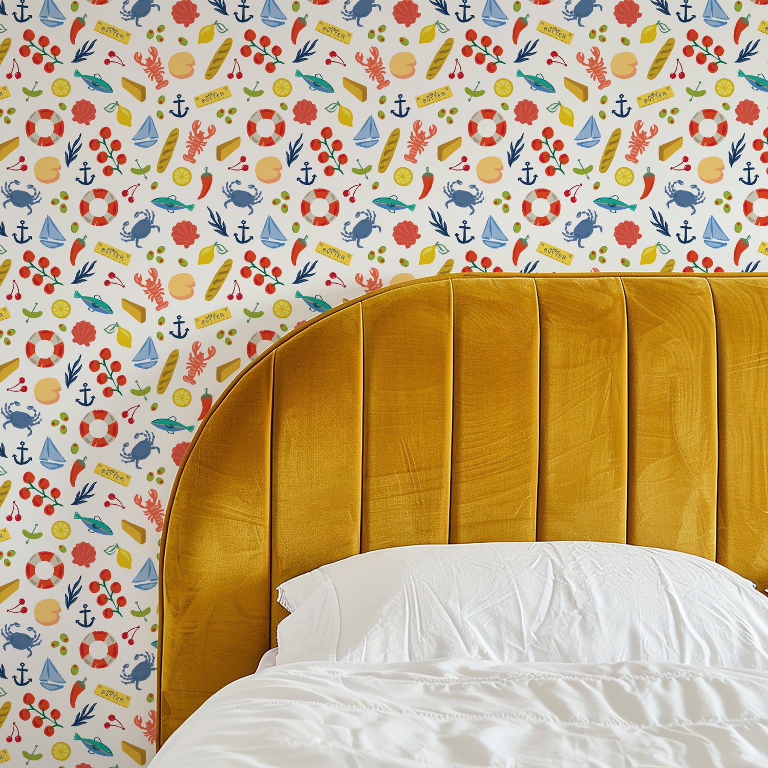 Yellow headboard against a colorful nautical-themed wallpaper