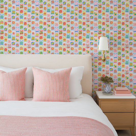 Bedroom with colorful wallpaper, pink checkered bedspread, and striped pillows.