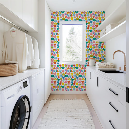 Modern laundry room with colorful wall design and washing machine.