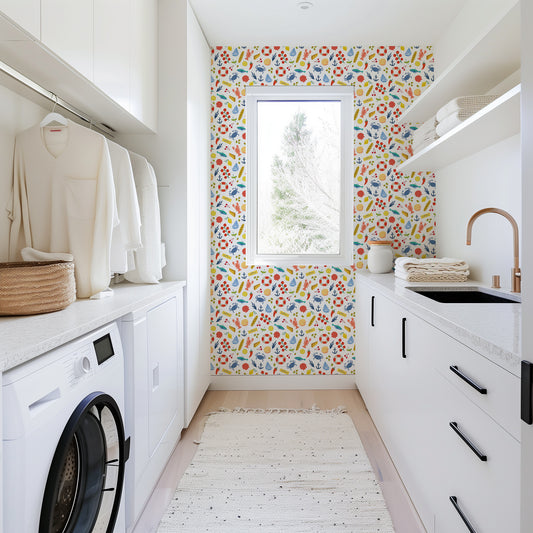 Modern laundry room with colorful wallpaper, washing machine, and cabinets.