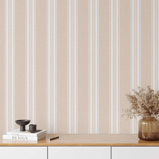 Linen Stripes Wallpaper in Soft Coral shown on a statement wall