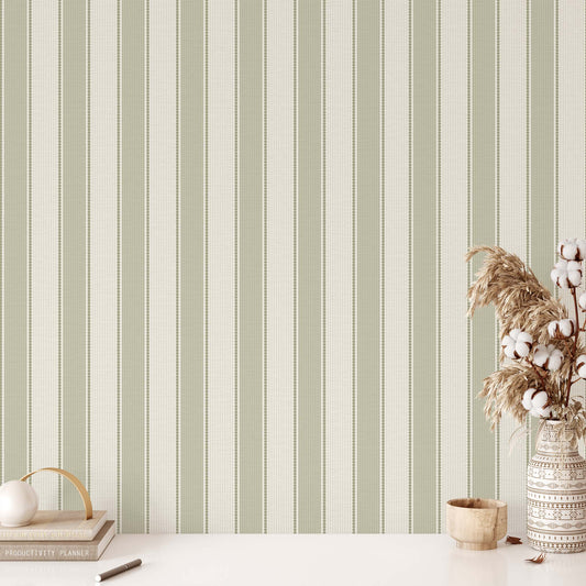 Striped wallpaper with a vase of cotton and decorative items on a table