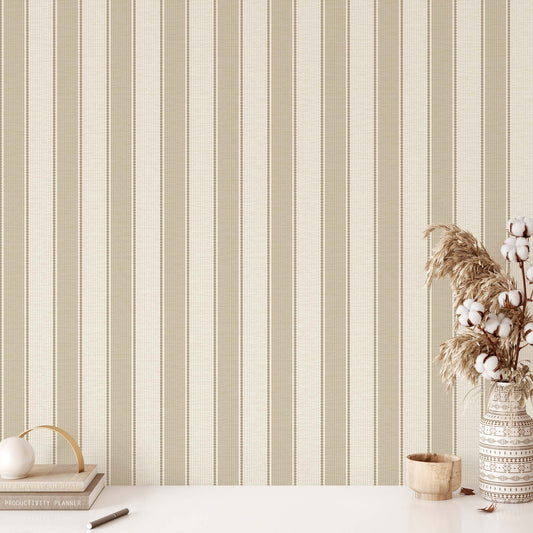 Striped wallpaper with a vase of cotton and decorative items on a table
