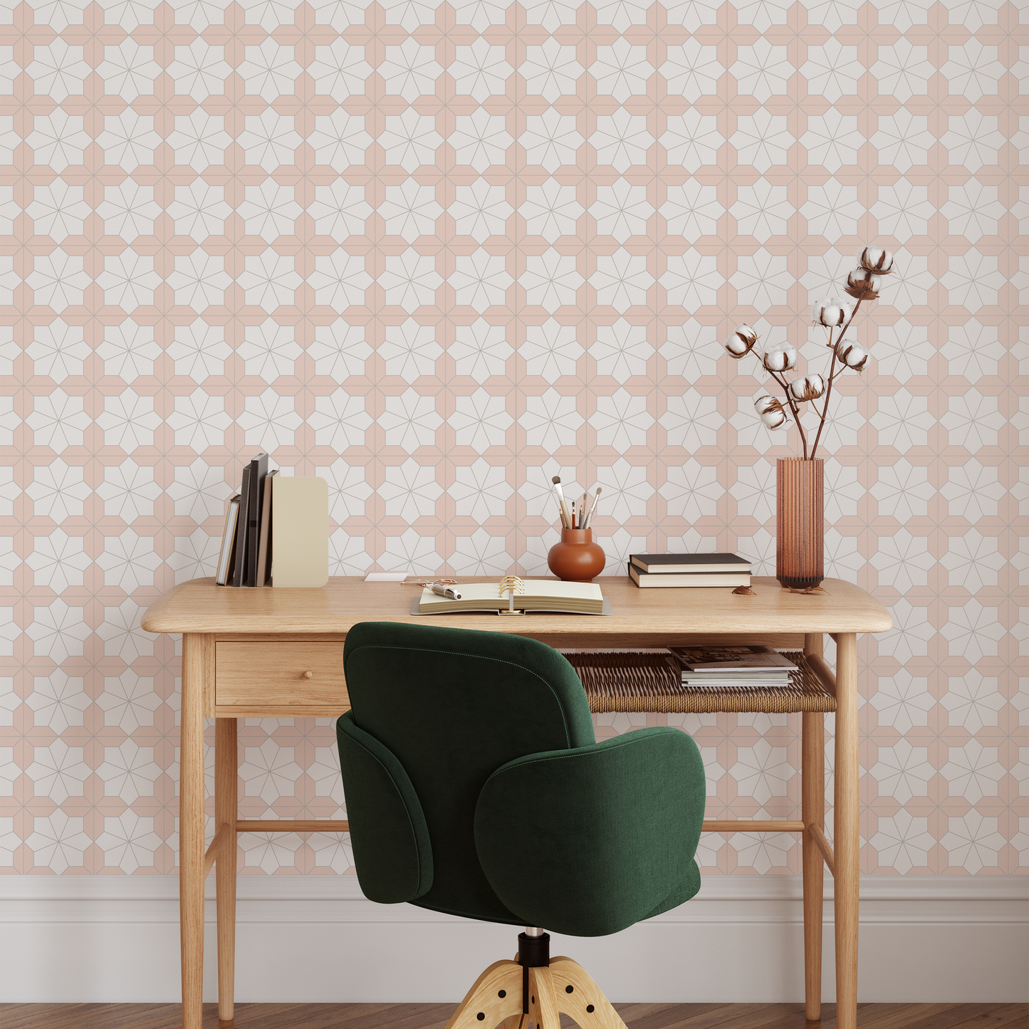 Wooden desk with a green chair against a peach wallpapered wall.