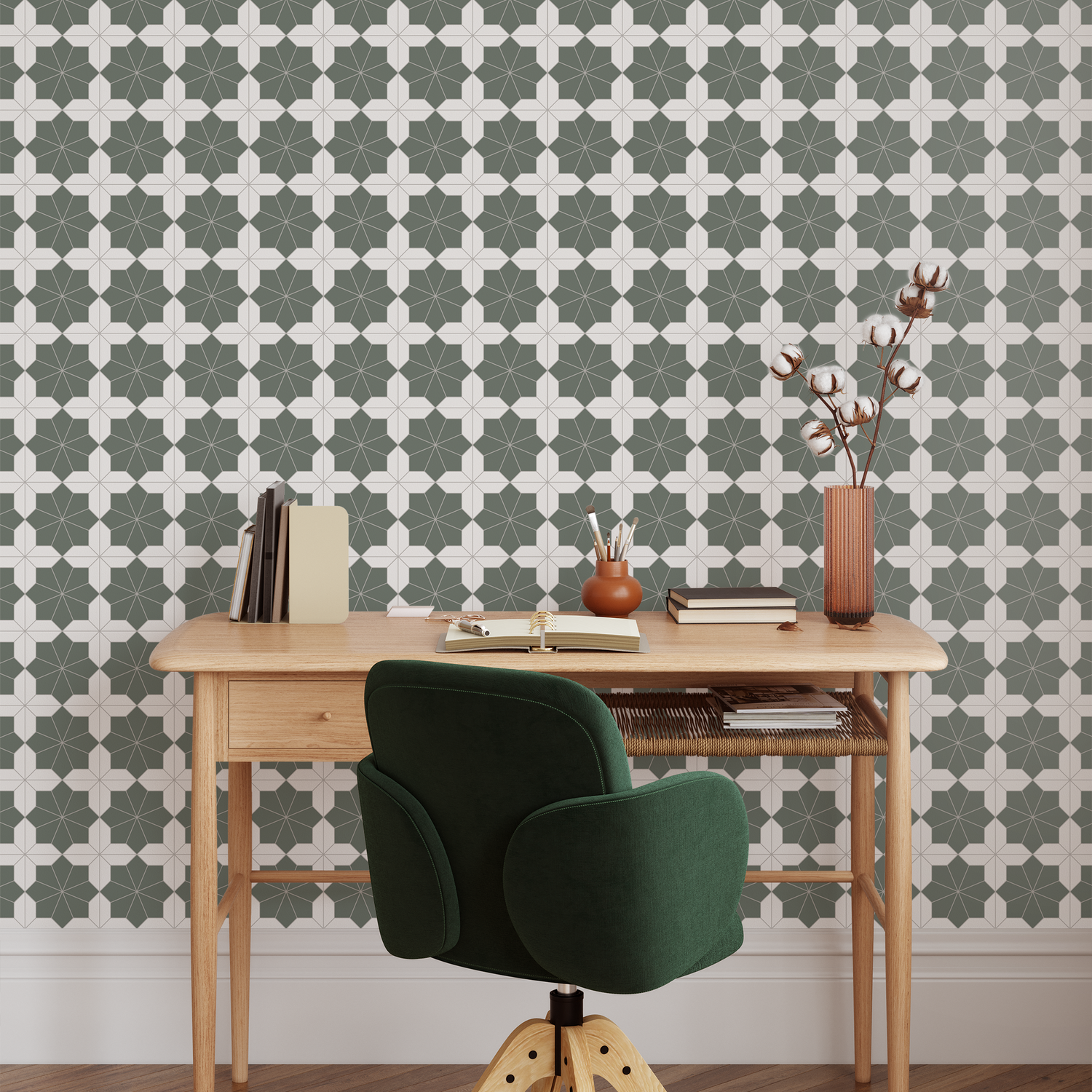 Wooden desk with a green chair against a geometric patterned wall.
