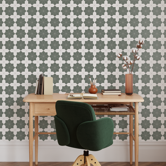 Wooden desk with a green chair against a geometric patterned wall.