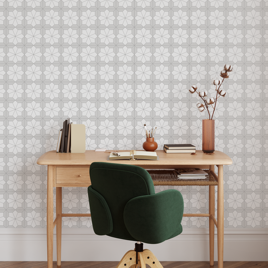 Home office with wooden desk, green chair, and decorative items against a Floral Mosaic Wallpapered wall.