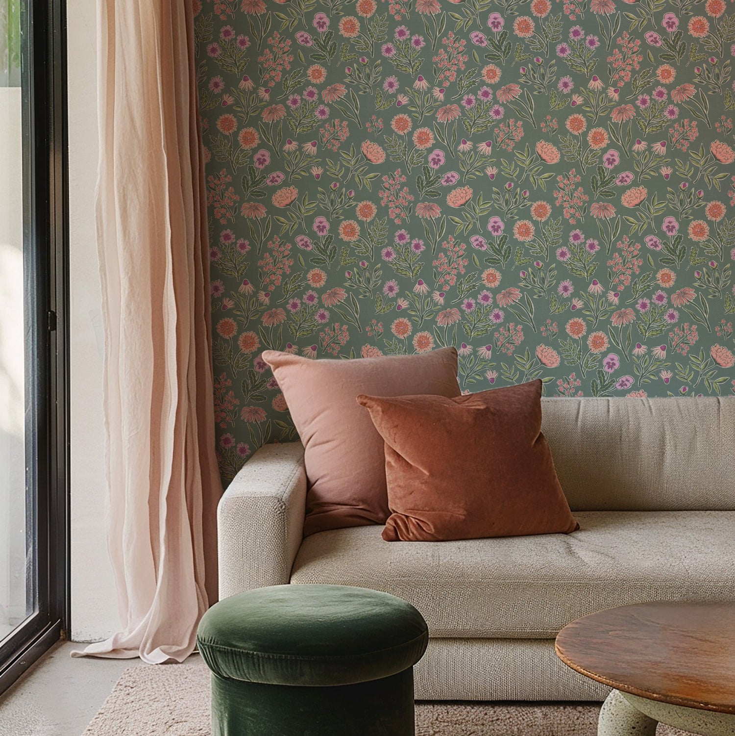 Sofa with pink and brown cushions against a floral wallpaper wall.